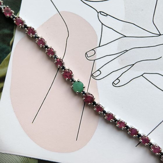 Silver bracelet with a 7.303-carat emerald, a ruby, and a sapphire