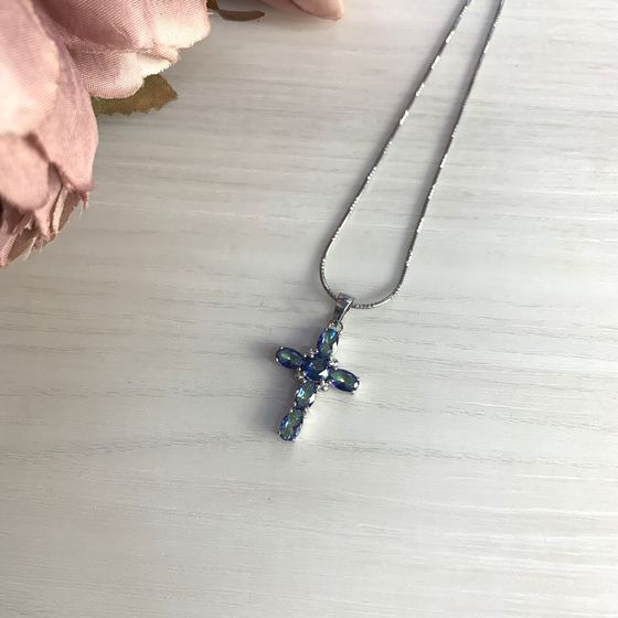 Silver cross with mystic topaz.
